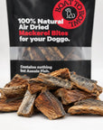 Close-up of air-dried mackerel bites for dogs with the mackerel treat bag in the background.