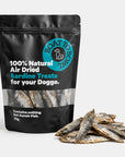 Air-dried sardine dog treats in a 70g black pouch with dried sardines beside the bag.