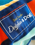 Close-up of a label on a dog hoodie with 'Soul Surfer Dolphin & Dog' text.