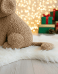 beautiful little plush toy of a brown dog, with a Christmas hat on