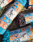 Dolphin & Dog product range of dog towels, beautiful packaging with colorful designs on a natural beach background