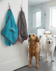 wet dogs in the bathroom, waiting to be dried, looking up at their dog towels by Dolphin and Dog.