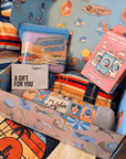 Handcrafted dog gift box with unique hand-drawn illustrations and premium wrapping for a personal gifting experience.