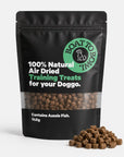Air-dried fish dog training treats in a black pouch with small treat pieces piled beside the bag.