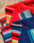 hooded beach towels, on the sand showing the reversible pattern