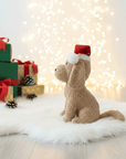 dog toy, a stuffed teddy of a dog with a Christmas hat on