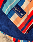Close-up of the hooded towel with a brand label that says "Dolphin and Dog"