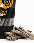 Close-up of air-dried fish skin straps for dogs with the fish skin treat bag in the background.