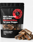 Air-dried mackerel bites for dogs in a 100g black pouch with mackerel pieces beside the bag.