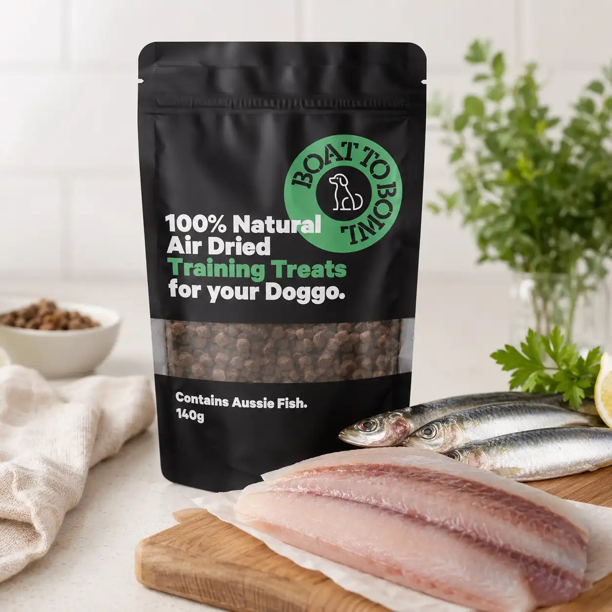 Boat To Bowl air-dried dog training treats displayed with fresh fish to show the Aussie fish ingredient source.