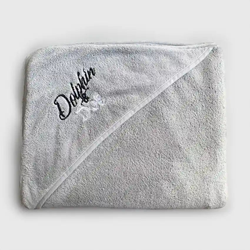 Dog towel folded up, pocket shows embroidery text 'Dolphin and Dog'. the dog towel has a high quality material being displayed on a white background.