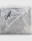 Dog towel folded up, pocket shows embroidery text 'Dolphin and Dog'. the dog towel has a high quality material being displayed on a white background.