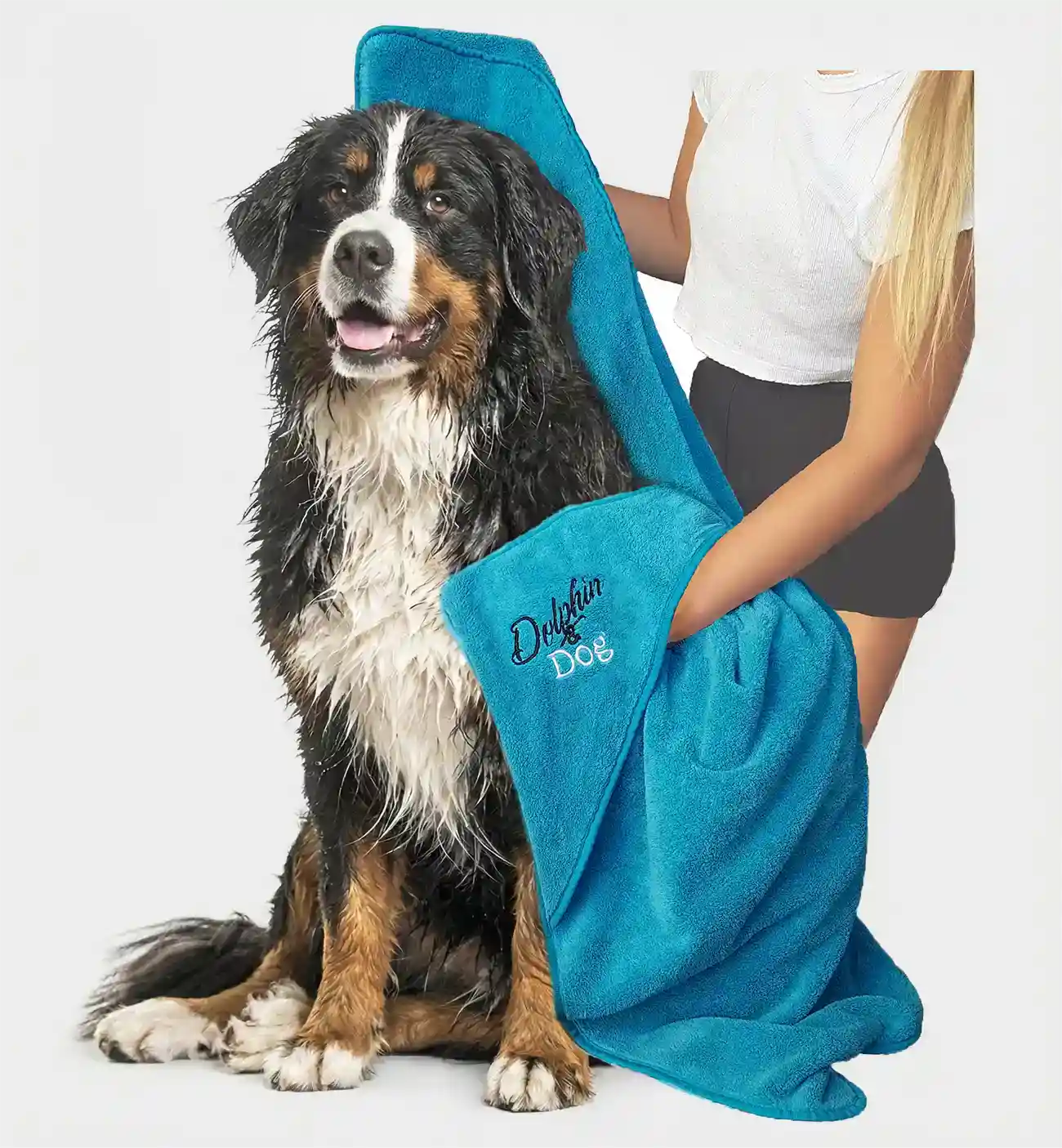 best dog towel, dog getting dried by a women. towel has hand pockets to help hold on to the dog while drying.