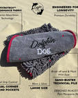 Dog towel with red accents on a sand background, featuring text about product features.