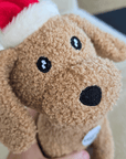 soft stuffed dog toy,  a brown dog with a Christmas hat on 