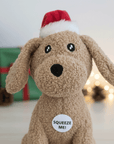 plush dog toy of a dog with a Christmas hat on