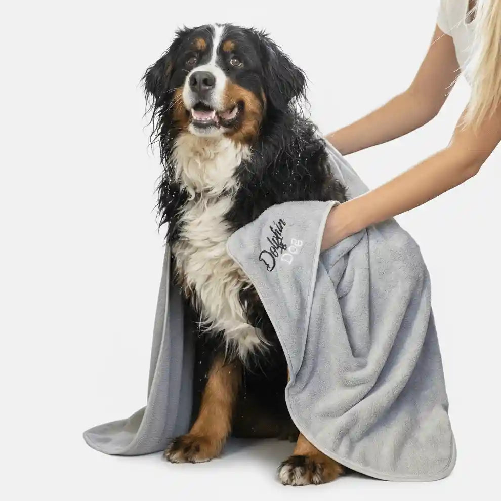 women using a dog towel to dry a dog , The large dog towel is silver and is made by Dolphin &amp; Dog.