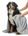 Dog towel being used to dry a dog, The large dog towel is silver and is made by Dolphin & Dog.