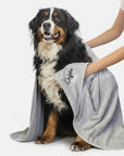 women using a dog towel to dry a dog , The large dog towel is silver and is made by Dolphin & Dog.