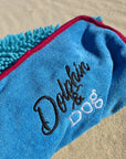 Close-up detail of the Dolphin & Dog logo and soft towel texture on the super absorbent dog towel