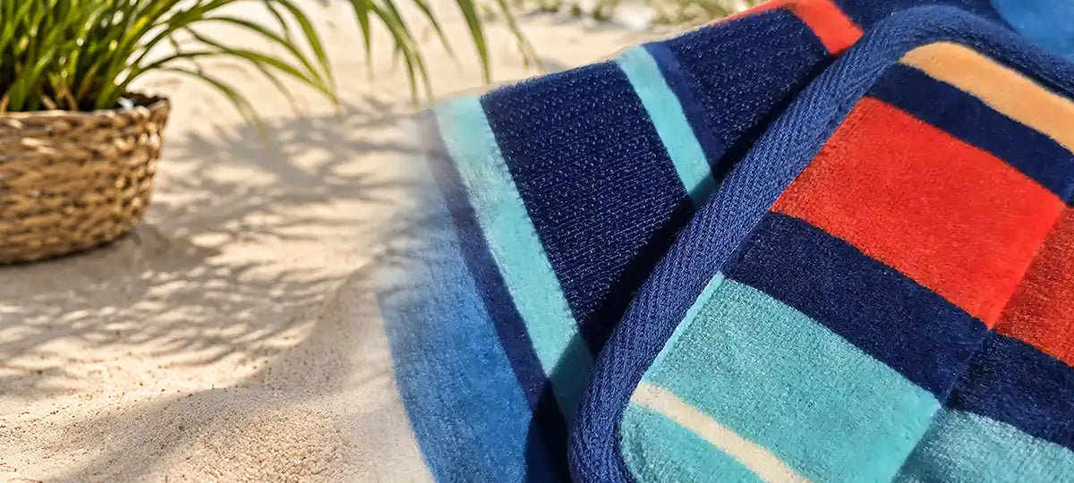 Striped dog drying robe on a beach