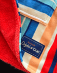 Close-up of a colorful kids towel with a brand label with "Dolphin and Dog" on a black background